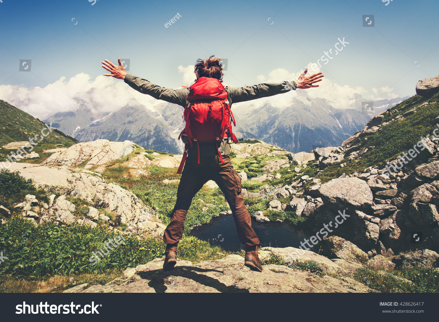 Traveler Man with backpack jumping hands raised mountains landscape on background Lifestyle Travel happy emotions success concept summer vacations outdoor
 #428626417