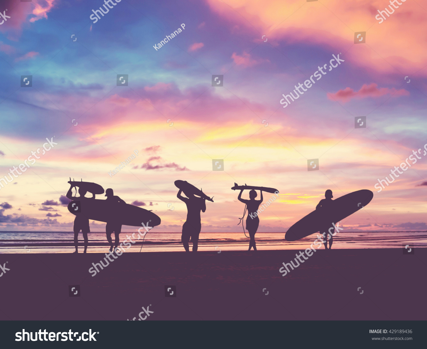 Silhouette Of surfer people carrying their surfboard on sunset beach, vintage filter effect with soft style #429189436