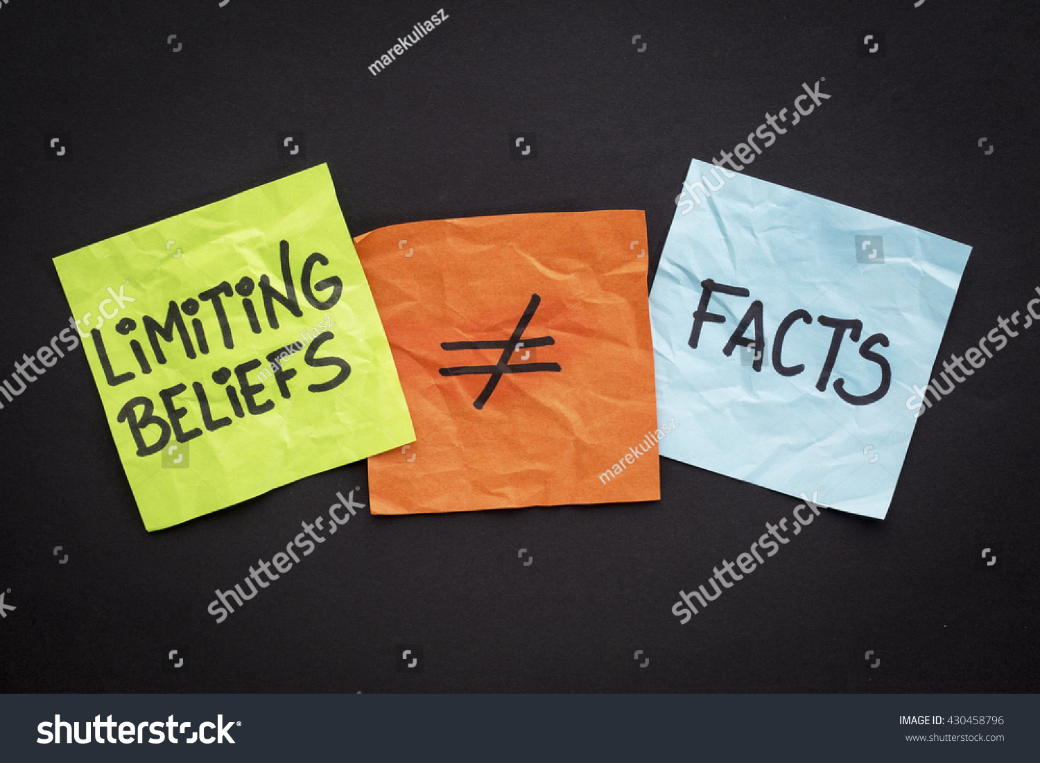 limiting beliefs are not facts concept - handwriting on sticky notes against black paper background #430458796