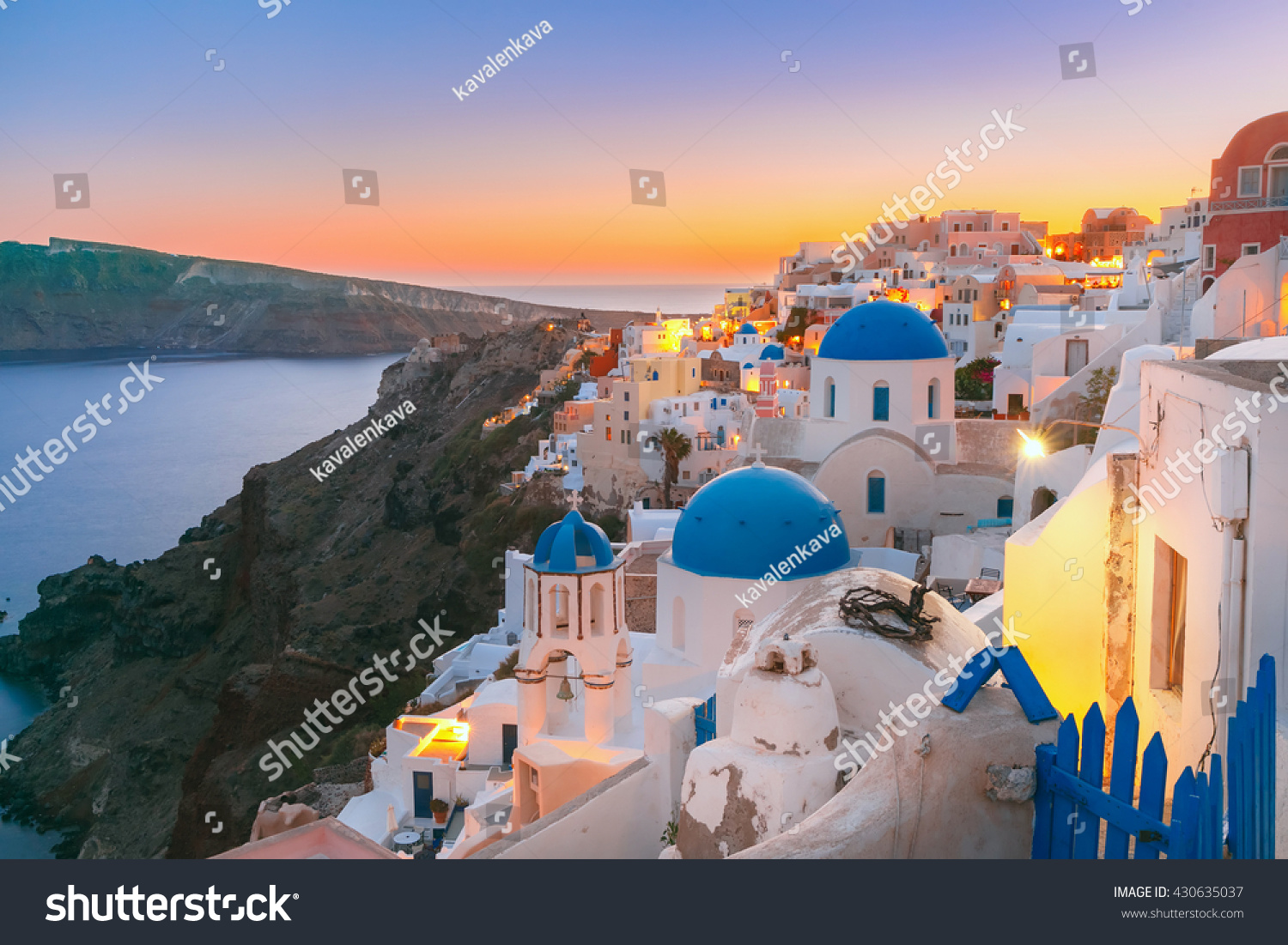Picturesque view, Old Town of Oia or Ia on the island Santorini, white houses and church with blue domes at sunset, Greece #430635037