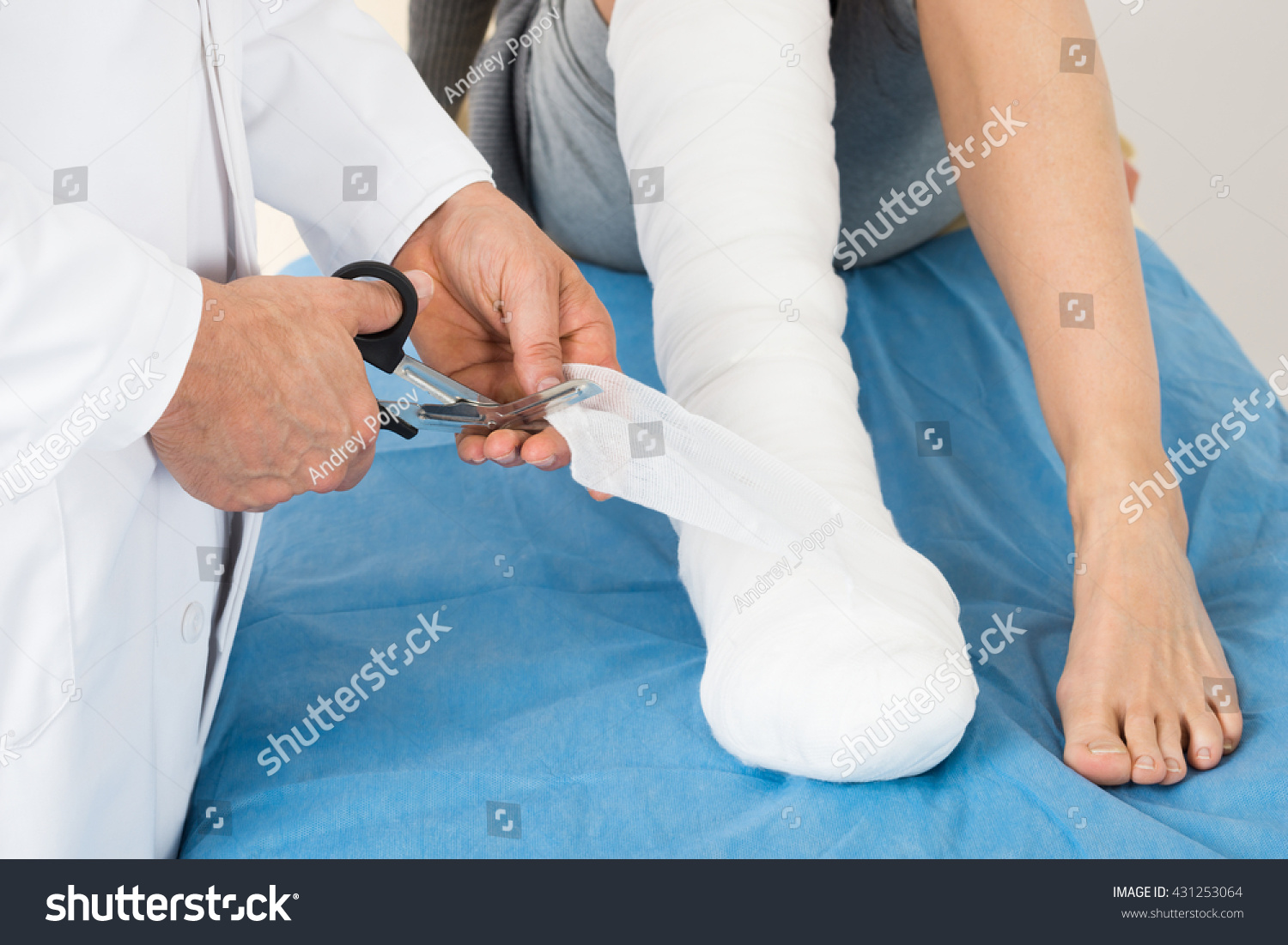 Doctor Bandaging Leg Of Patient In Hospital #431253064
