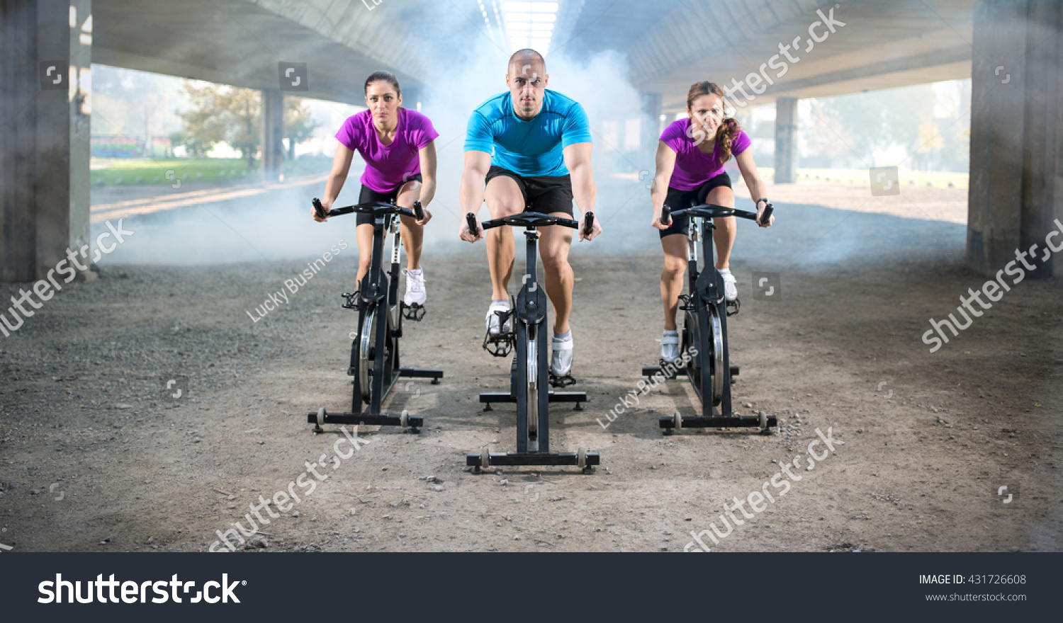 group of people doing spinning on cycle bike outdoor #431726608