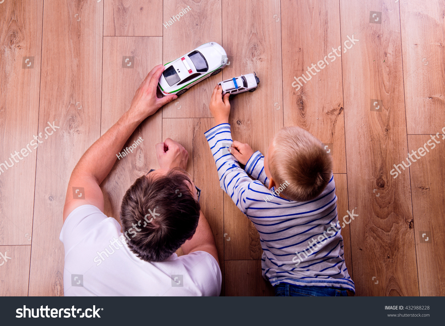 Unrecognizable father with his son playing with cars #432988228