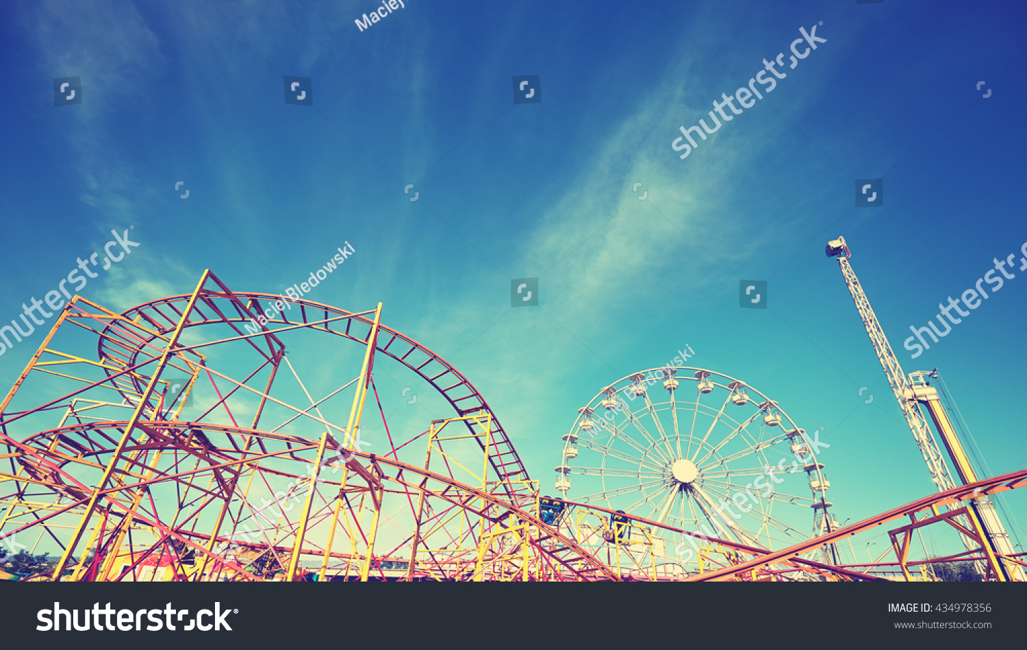 Vintage toned picture of an amusement park. #434978356