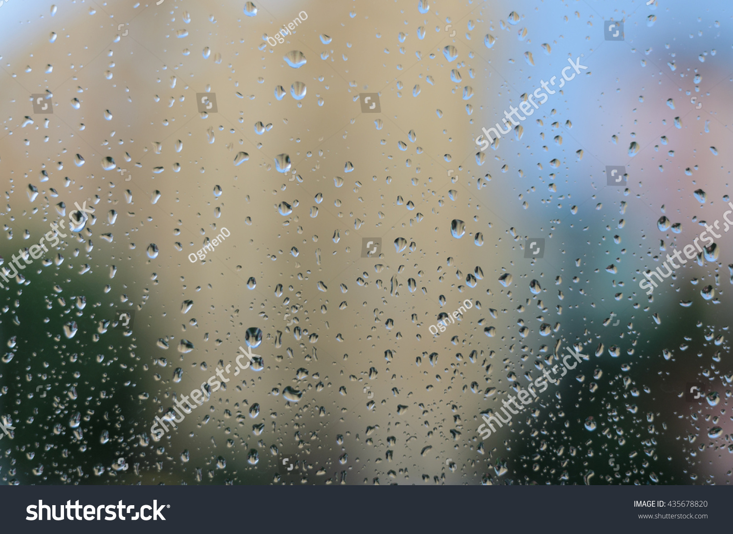 Rain drops on glass with a background #435678820