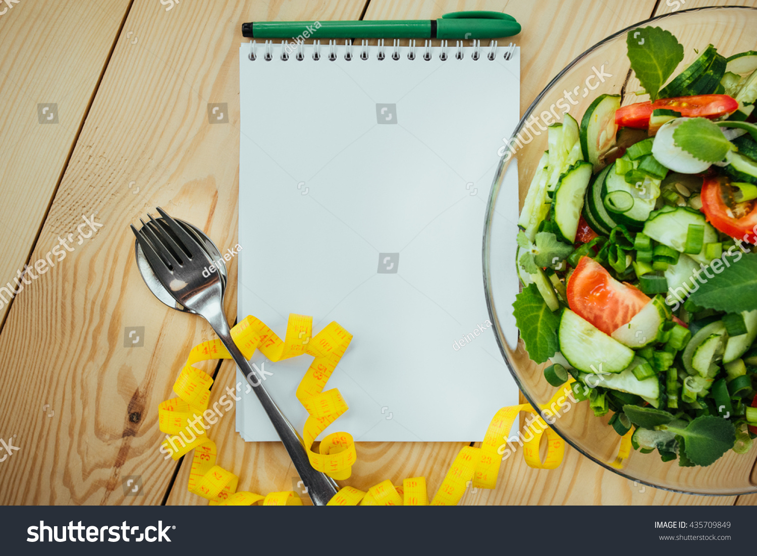 Diet plan, menu or program, tape measure and diet food of fresh salad on wood background, weight loss and detox concept, top view #435709849