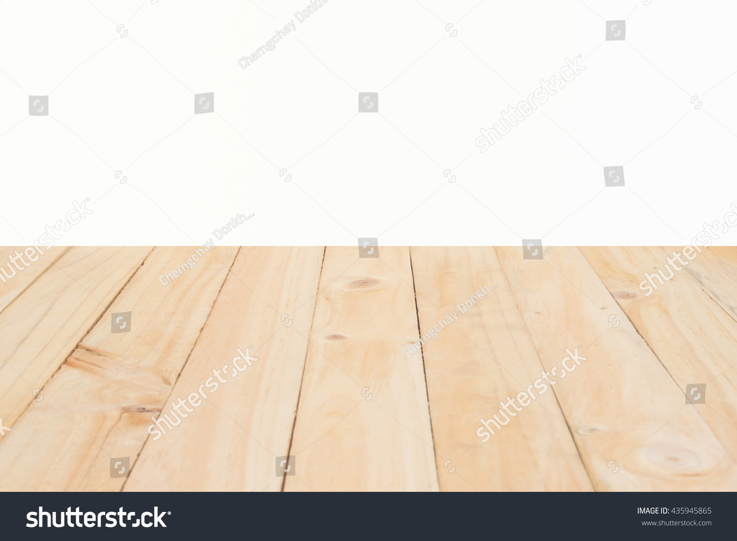 Copyspace background with an empty white wall with a hardwood wooden floor below with large copy space for your text or advertisement #435945865