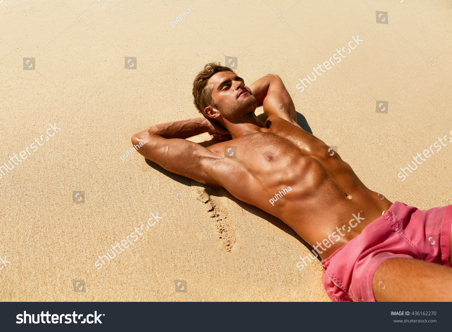 Man Body On Beach In Summer. Handsome Sexy Fit Male With Healthy Skin Sun Tan Tanning At Luxury Relax Spa Resort. Beautiful Fitness Model Relaxing, Sunbathing Lying On Sand. Summertime Travel Vacation #436162270