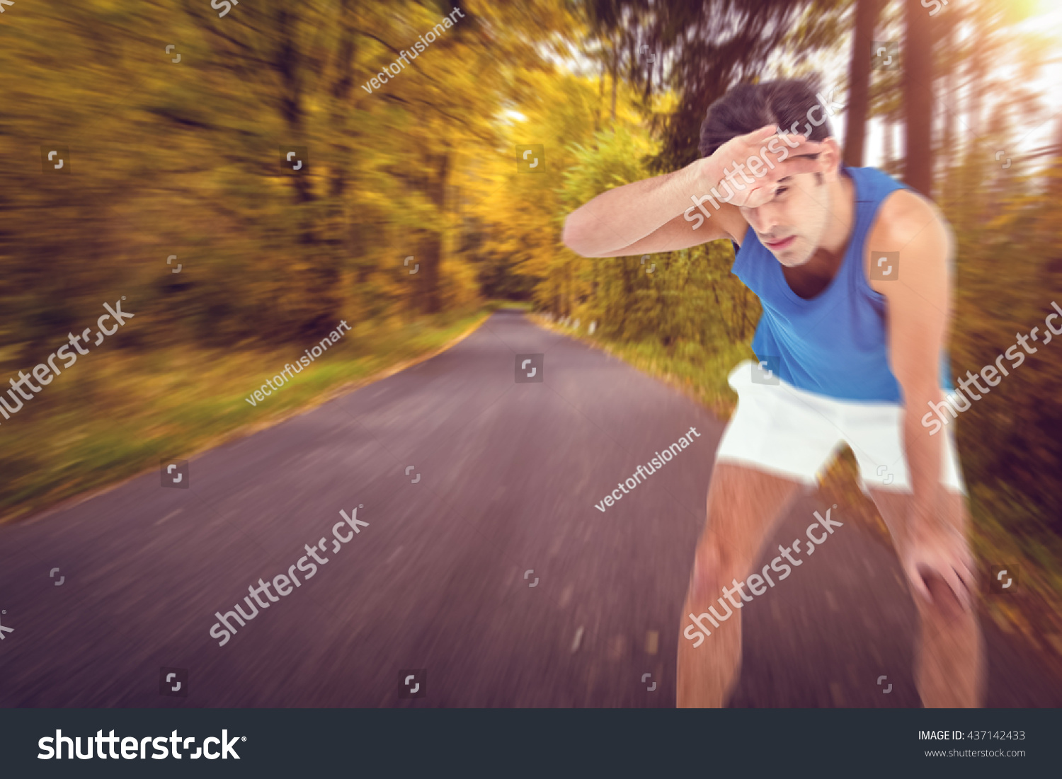 Tired athlete wiping his sweat with hand against country road along trees in the lush forest #437142433