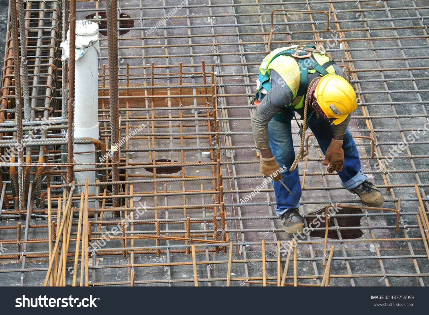 MALACCA, MALAYSIA -MAY 27, 2016: Construction workers fabricating steel reinforcement bar at the construction site in Malacca, Malaysia. The reinforcement bar was ties together using tiny wire.   #437759098