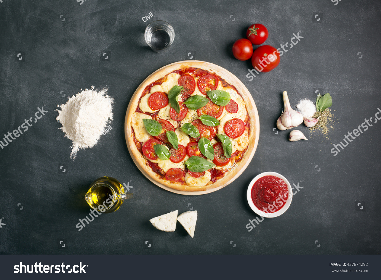 Pizza (margherita) and ingredients on the black chalkboard  #437874292