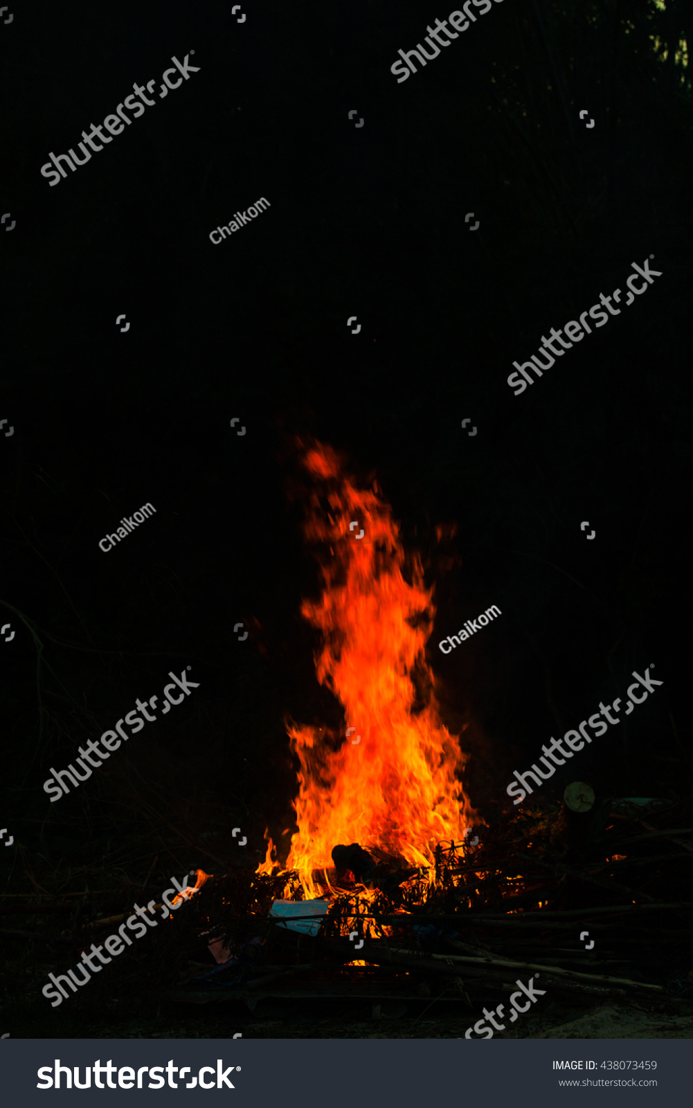 Flames in a bonfire on black background #438073459