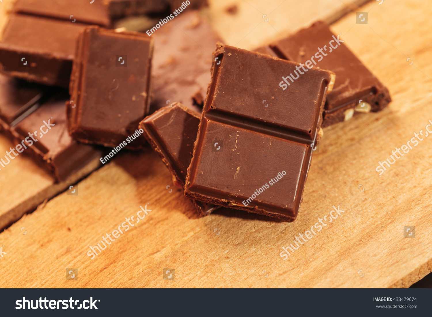 pieces of dark chocolate on a wooden background. #438479674