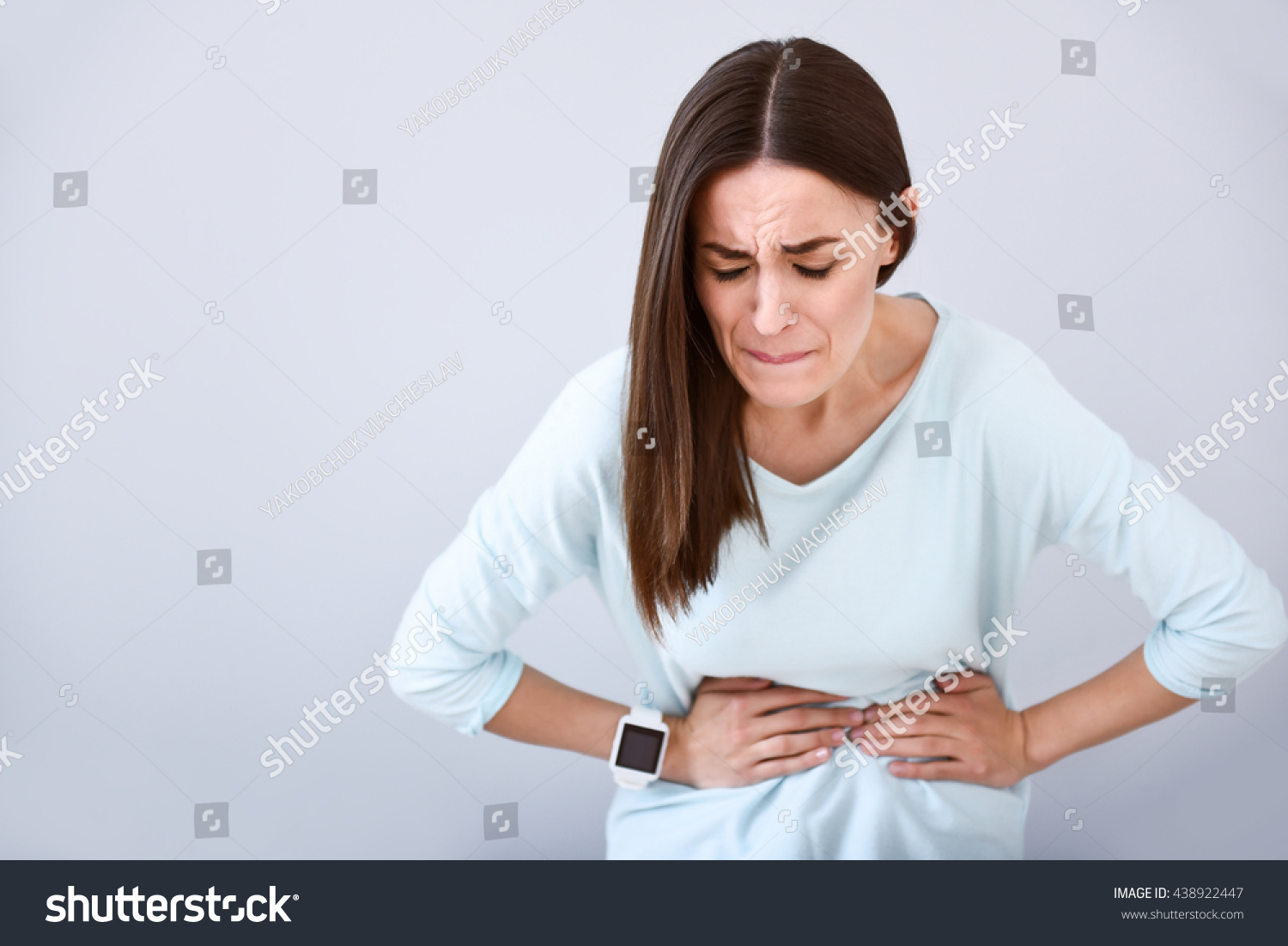Sick woman having a stomach ache #438922447
