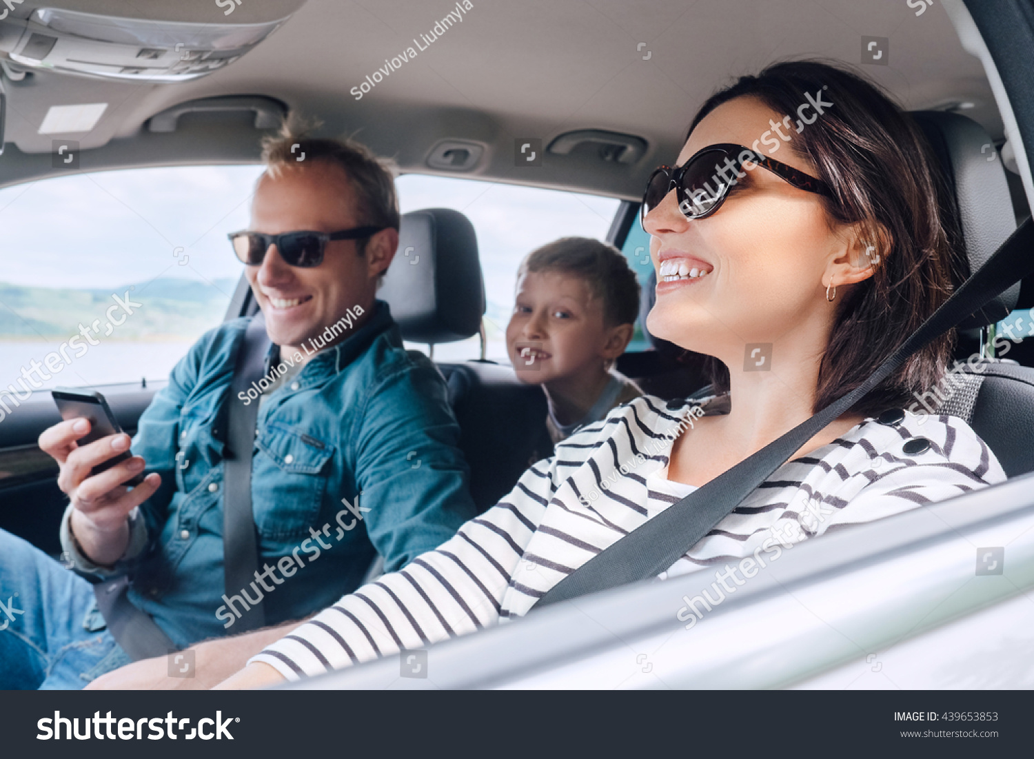 Happy family riding in a car #439653853