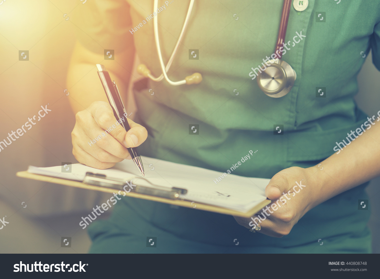  female doctor,surgeon,nurse,pharmacy with stethoscope on hospital holding clipboard,writing a prescription,Medical Exam,Healthcare and medical concept,test results,vintage color,selective focus #440808748