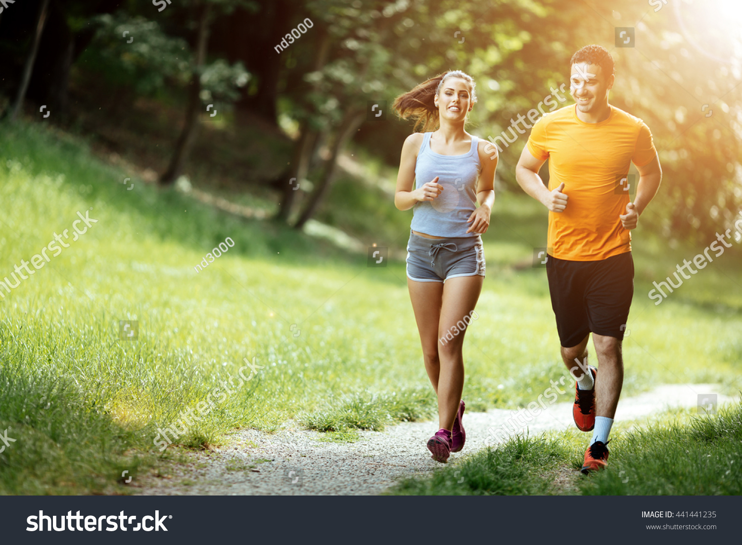 Beautiful couple jogging in nature living healthy #441441235