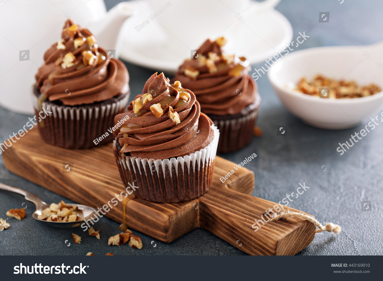 Chocolate caramel cupcake with nuts and butterscotch syrup #443169010