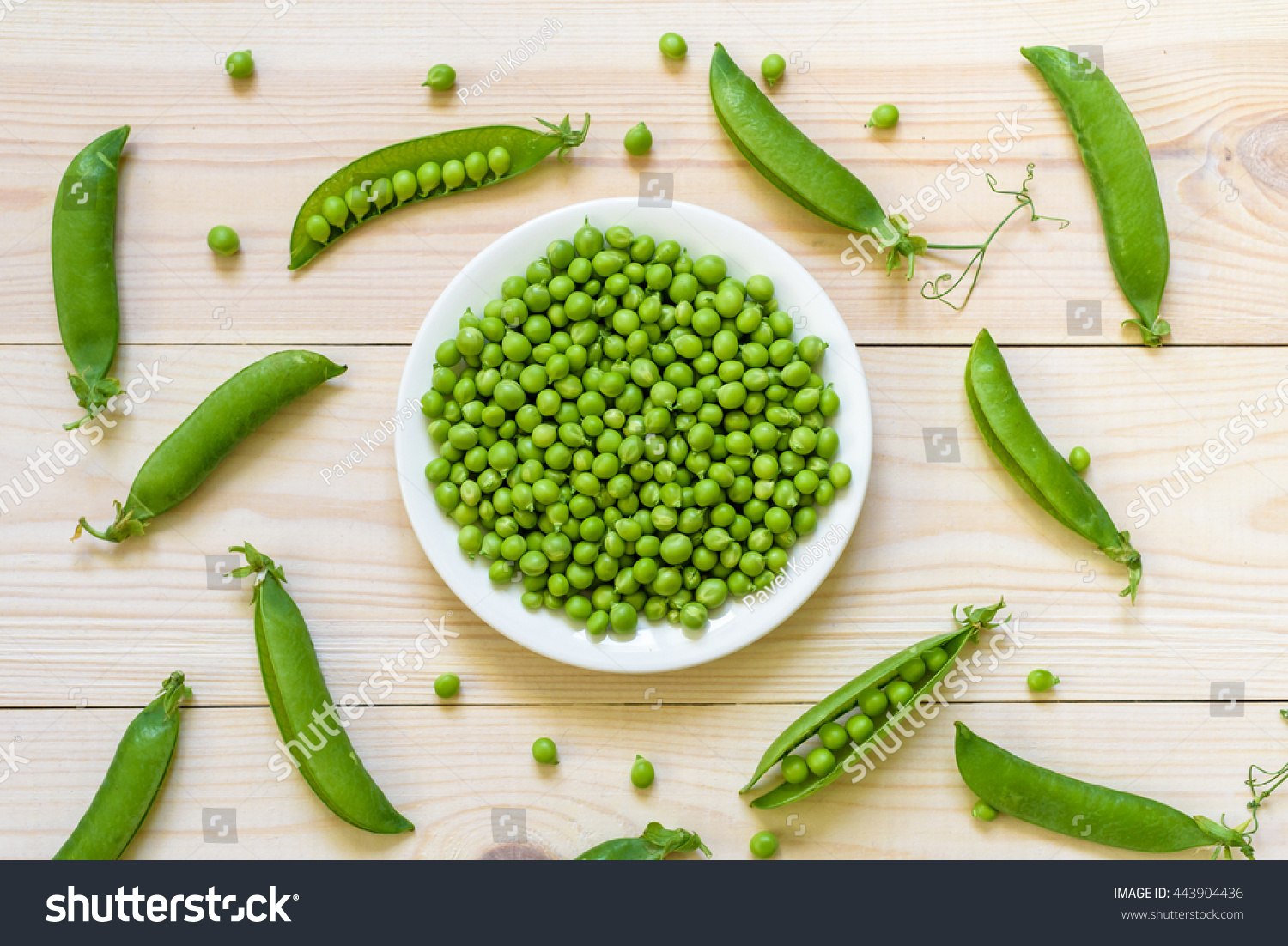 Green pea in bowl of top view on rustic wooden background with copy space, natural wooden table. Flat lay.  #443904436