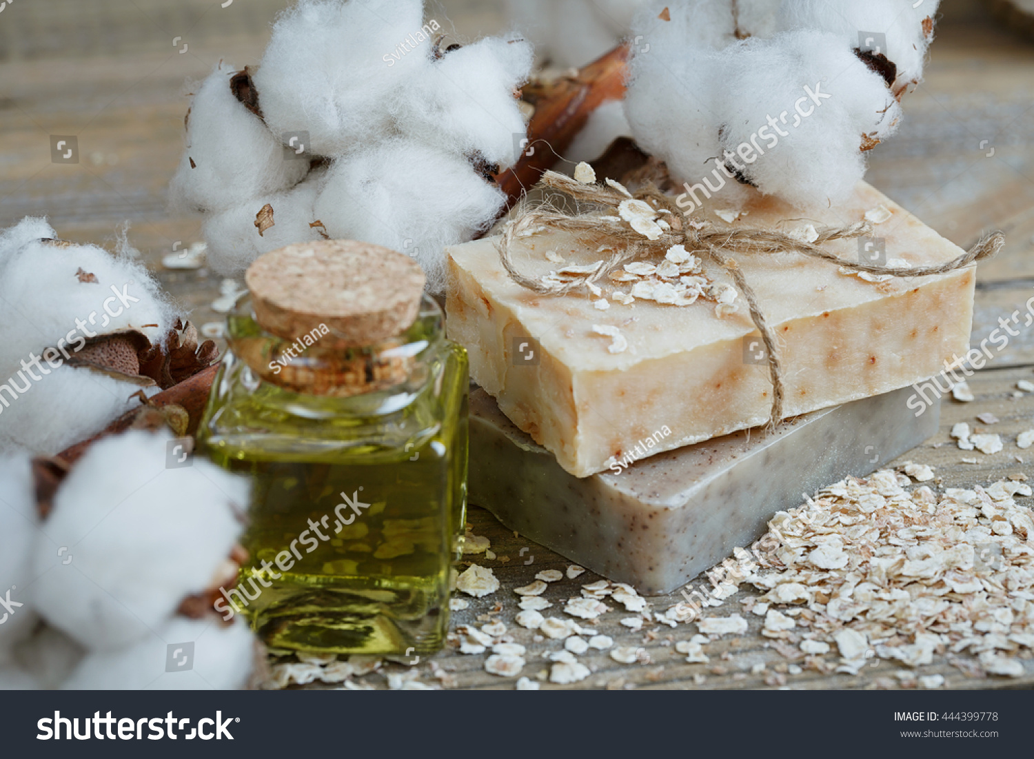 Natural handmade soap, oat flakes, aromatic oil and cotton branch on wooden background. Spa concept. #444399778