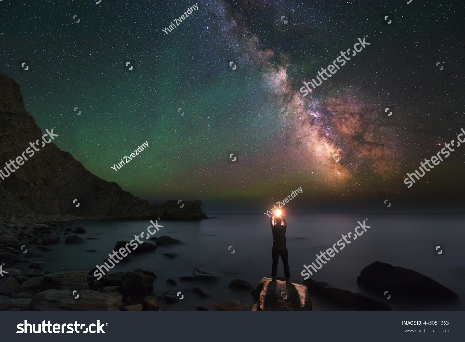 Man and Universe, shore of the ocean, sea, fire and stars in hands, in palms, igniting stars, Inspiration photo, unity the man and universe, astronomy and astrophotography, Milky Way, green airglow #445051363