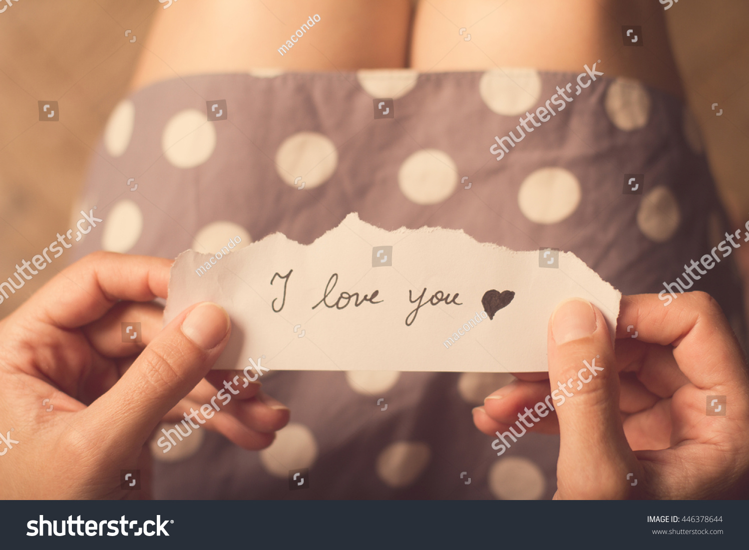 Top view of woman in dotted dress holding a paper message with the text I love you #446378644