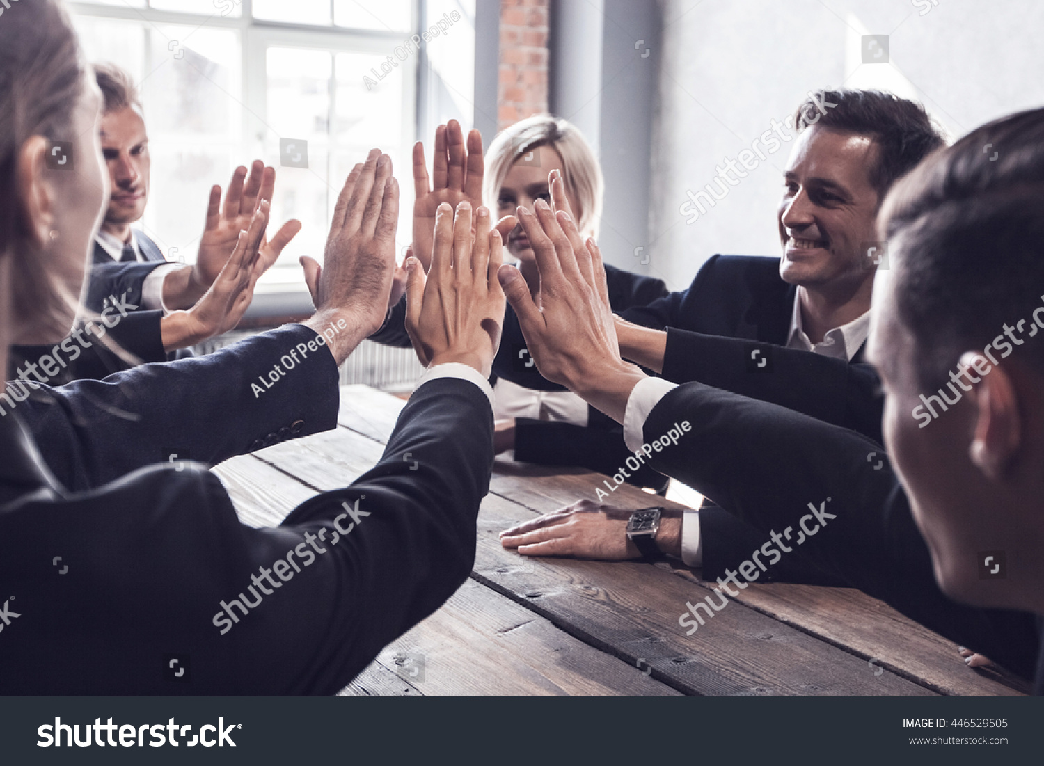 Business people give high five at business meeting #446529505