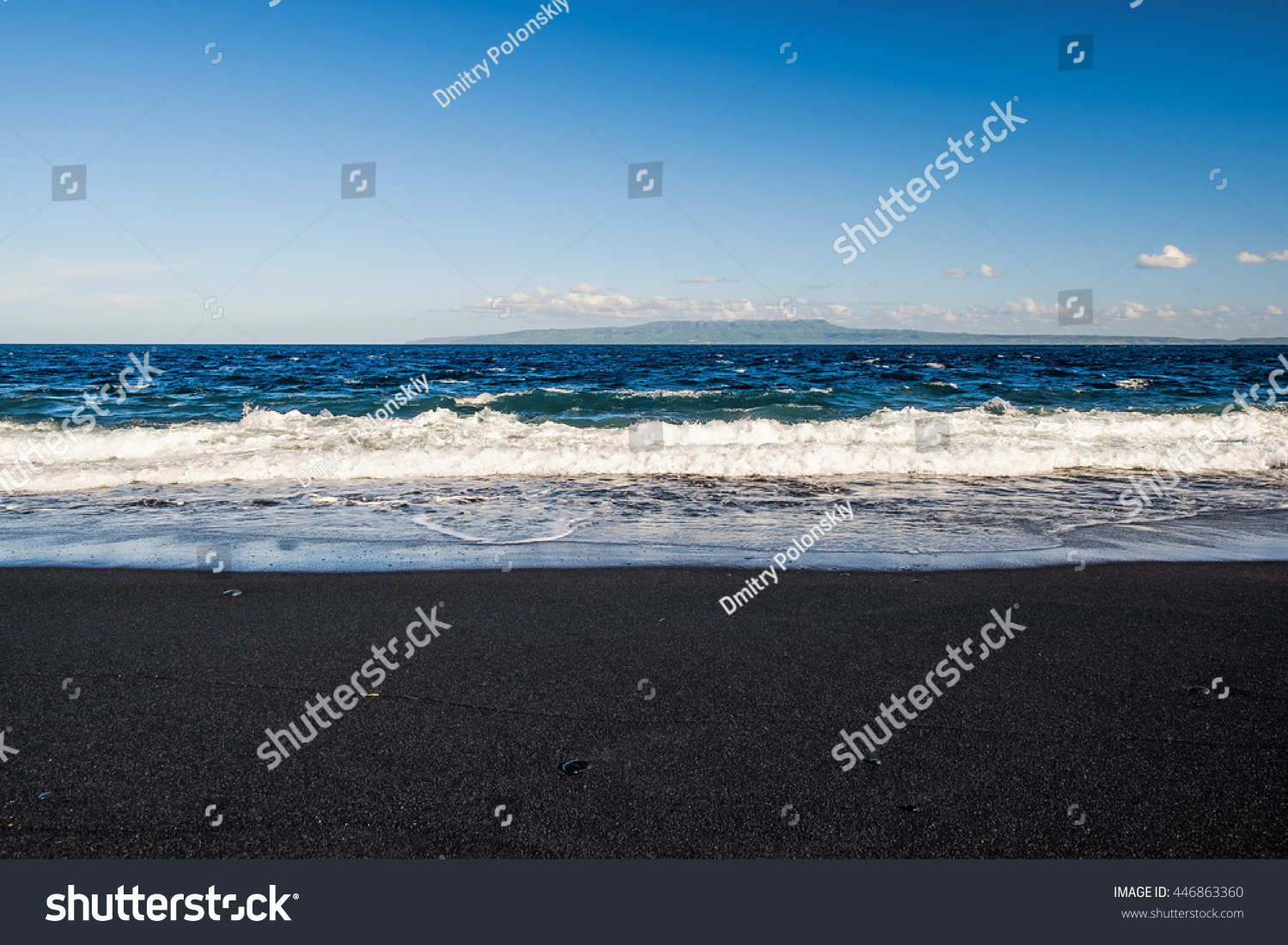 Black volcanic beach near blue sea in Bali island, Indonesia. Island sea shore line with exotic black sand, Bali. Black sea shore sand from Agung volcano, Bali. Volcanic beach in Bali, Indonesia. #446863360