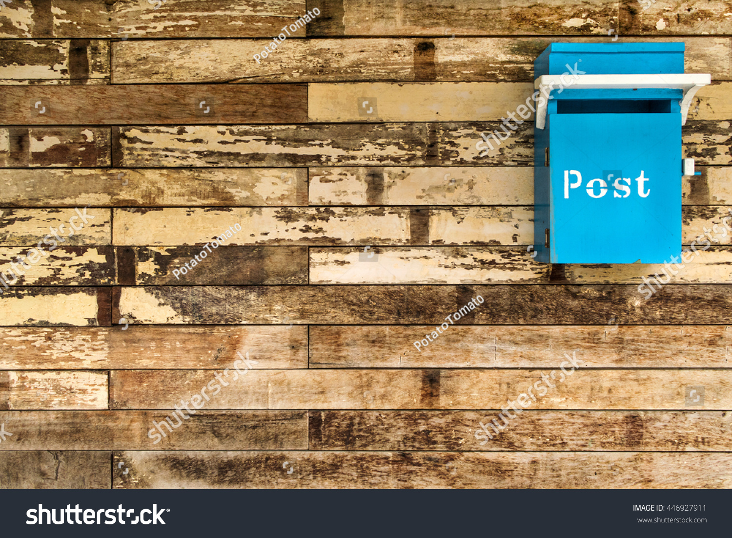 Cyan (Light blue) postbox on the old rough wooden wall #446927911