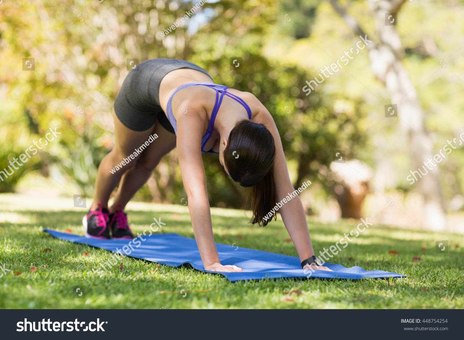 Young woman doing yoga in park #448754254