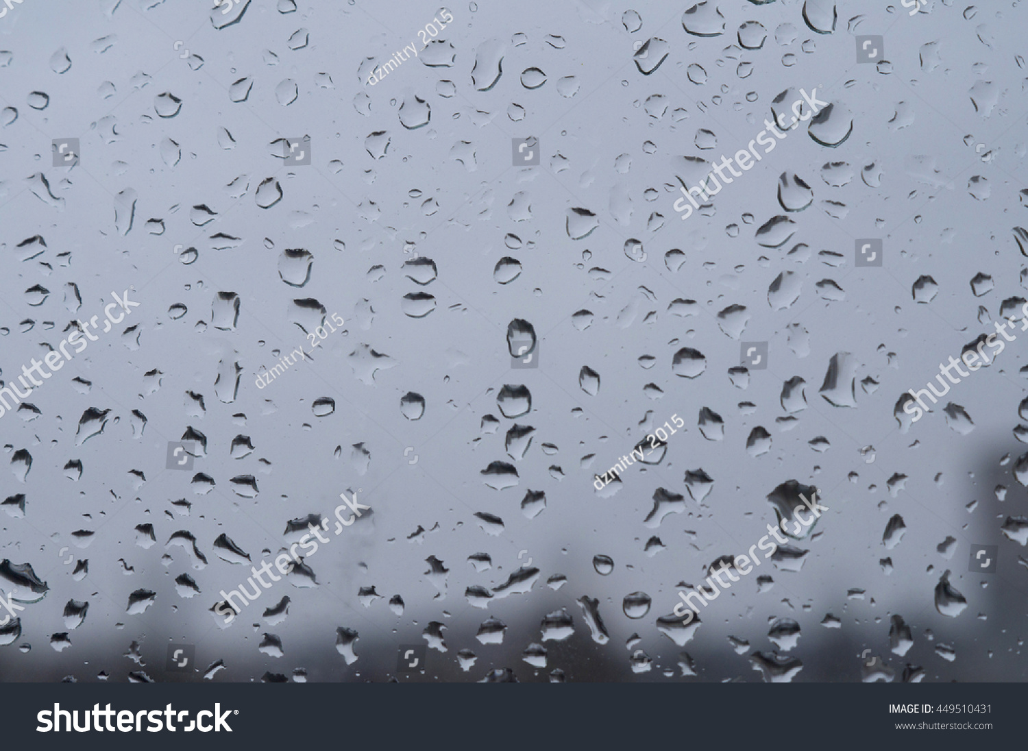 Drops of rain on a window pane #449510431
