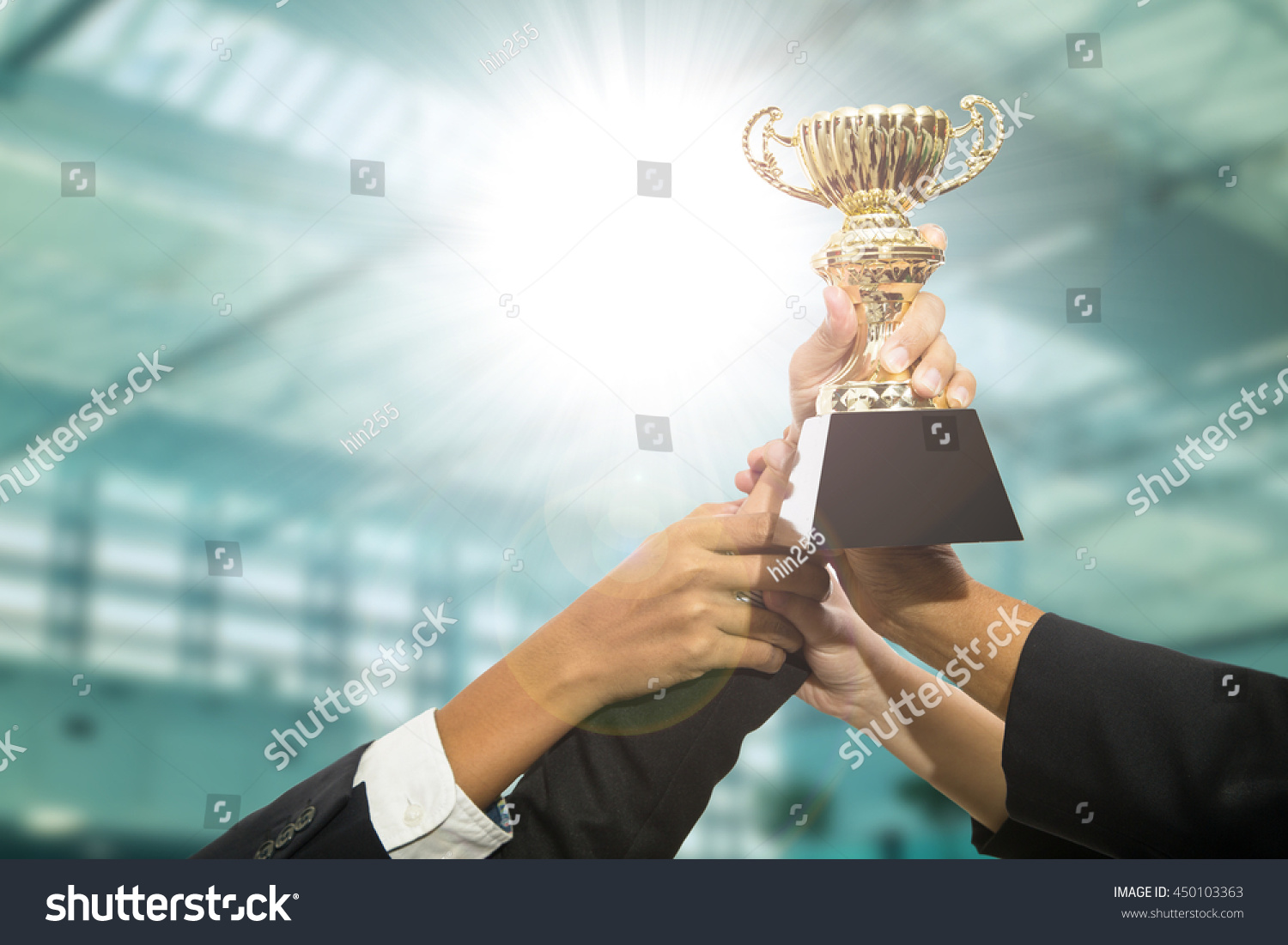 Businessman team holding award trophy for show their victory. #450103363