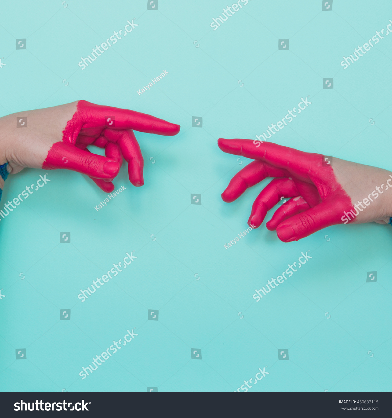 Two painted hands try to reach each other's fingers. Creative connecting conception.  #450633115