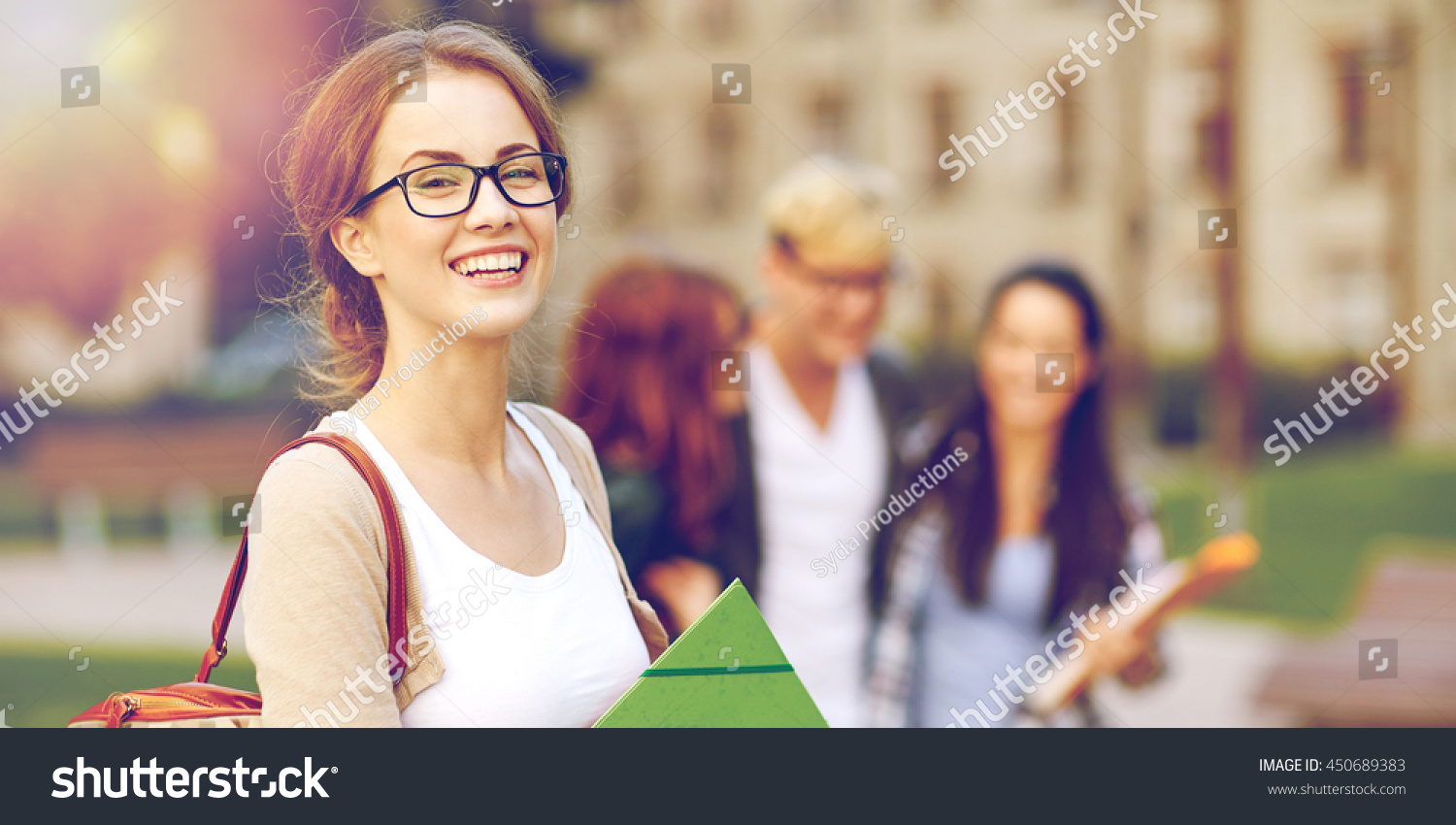 education, campus, friendship and people concept - group of happy teenage students with school folders #450689383