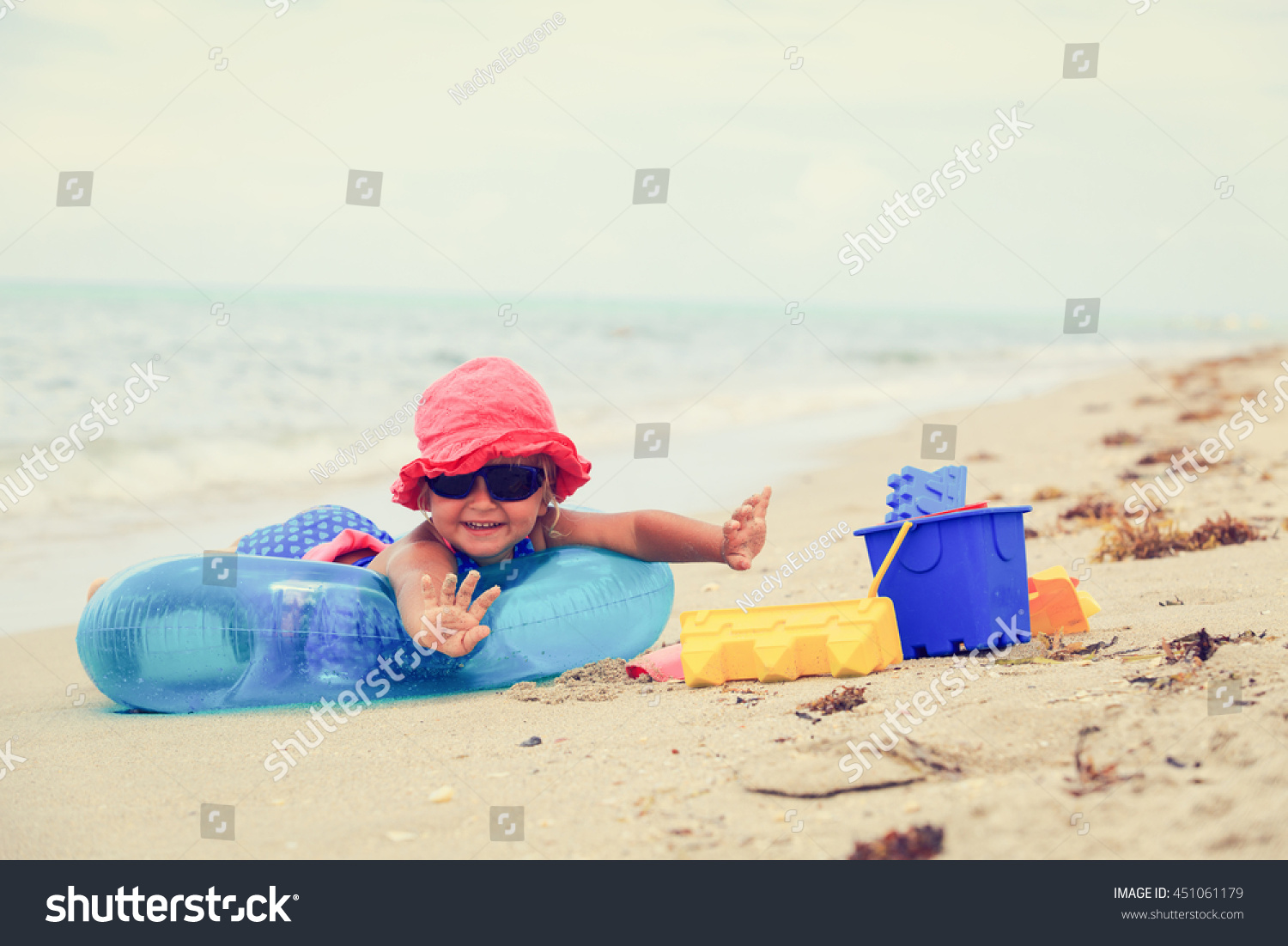 cute little girl play on summer beach #451061179