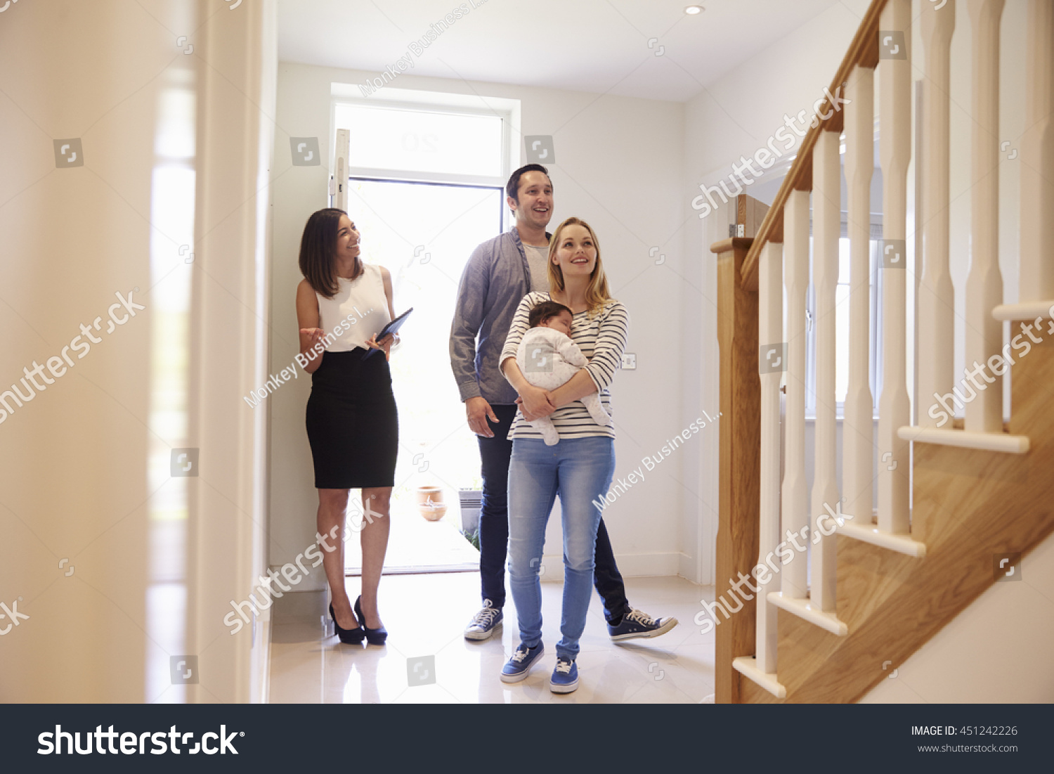 Realtor Showing Young Family Around Property For Sale #451242226