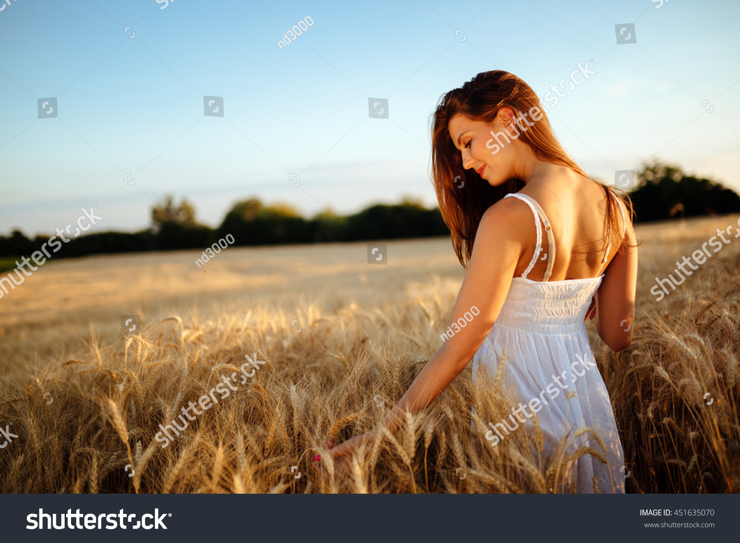 Romantic woman walking in golden fields of barley #451635070
