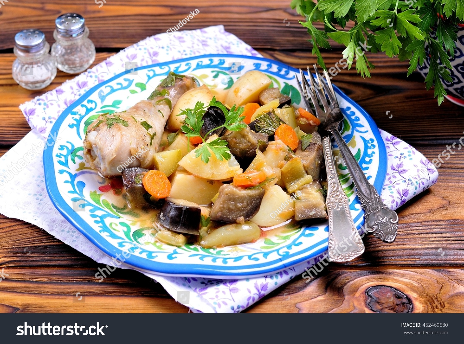 Chicken stew  with vegetables, potatoes, eggplant, zucchini, onions, carrots, tomatoes, garlic and parsley #452469580