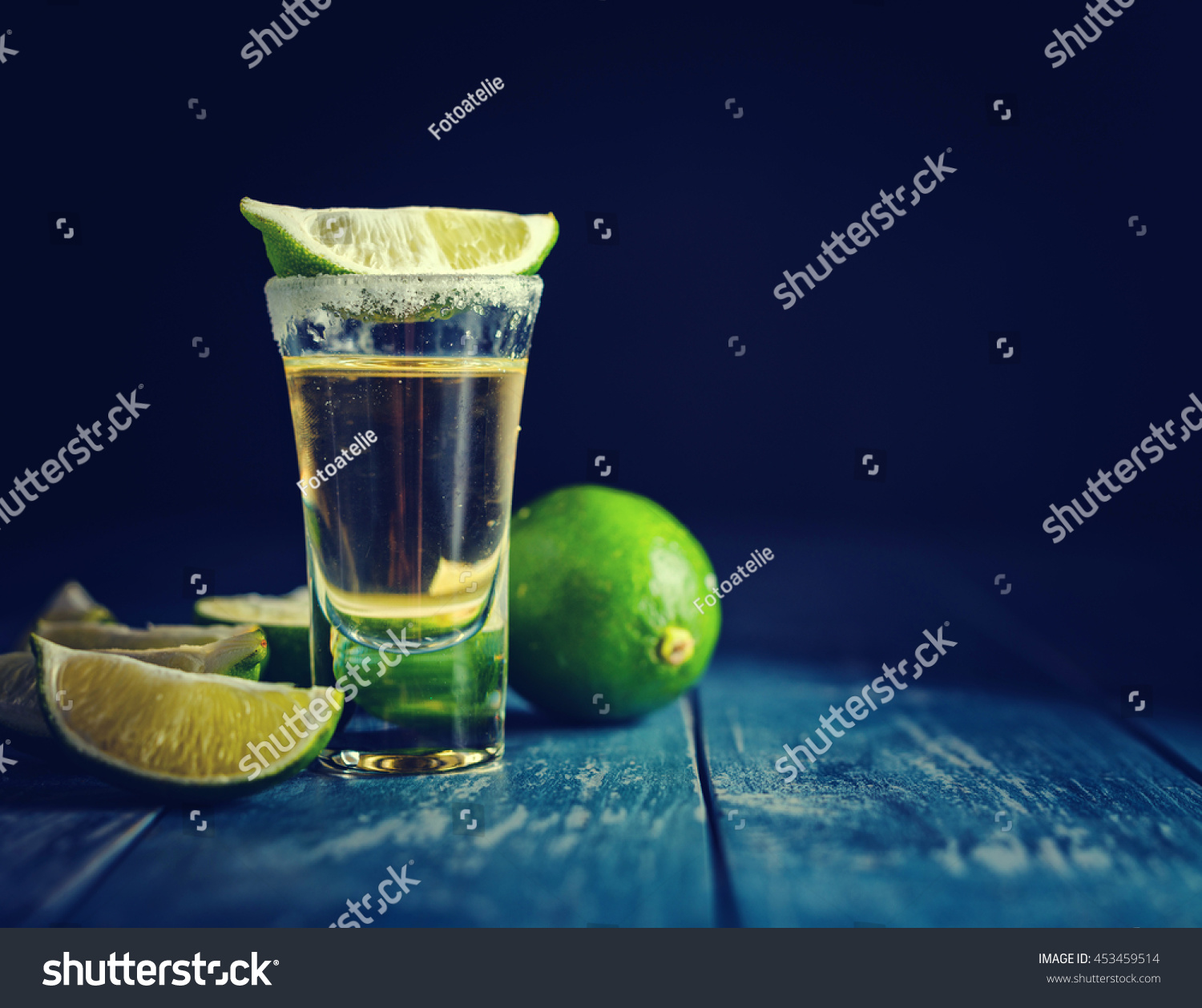 Mexican Gold Tequila with lime and salt on dark table. Toned. Retro style vintage color. Copyspace for text. #453459514