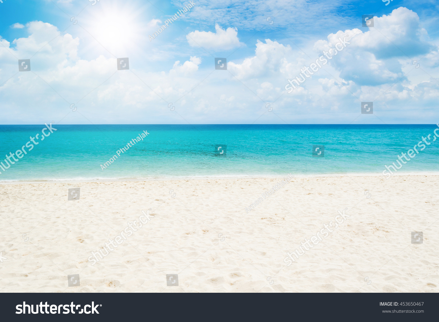 Beautiful white sand beach and tropical sea with bright sun #453650467