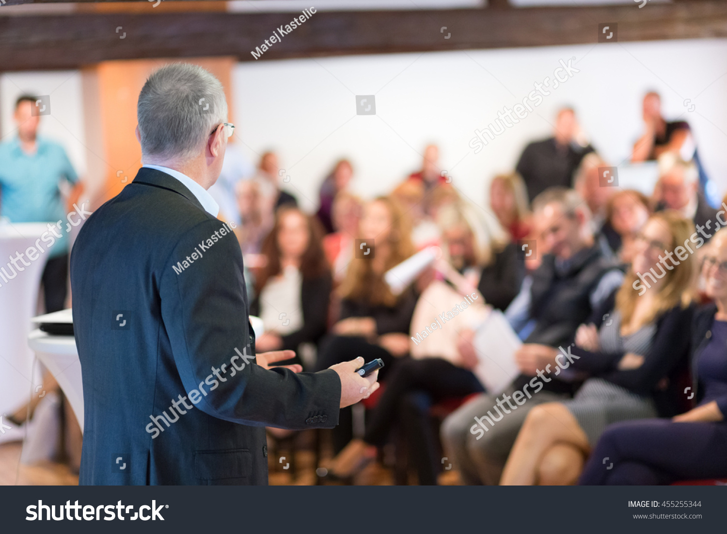 Speaker at Business Conference with Public Presentations. Audience at the conference hall. Entrepreneurship club. Rear view. Horisontal composition. Background blur. #455255344