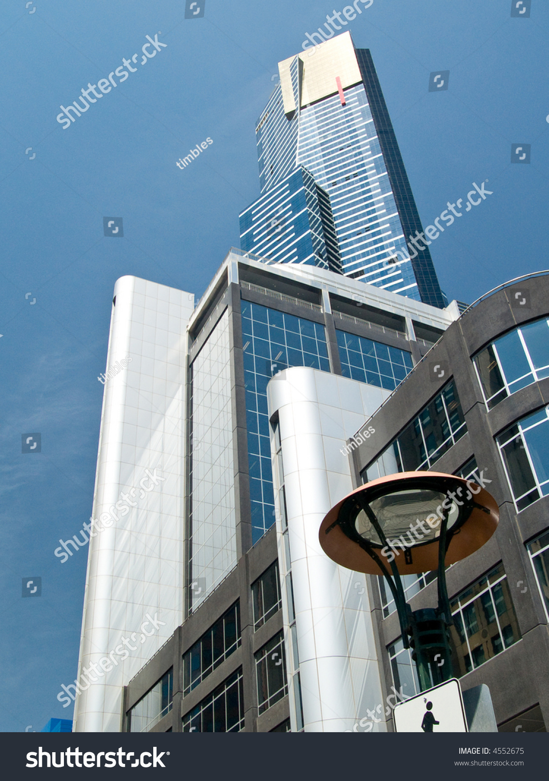 A collection of tall modern buildings looking skywards.  Shot against a blue sky, with fine cloud #4552675
