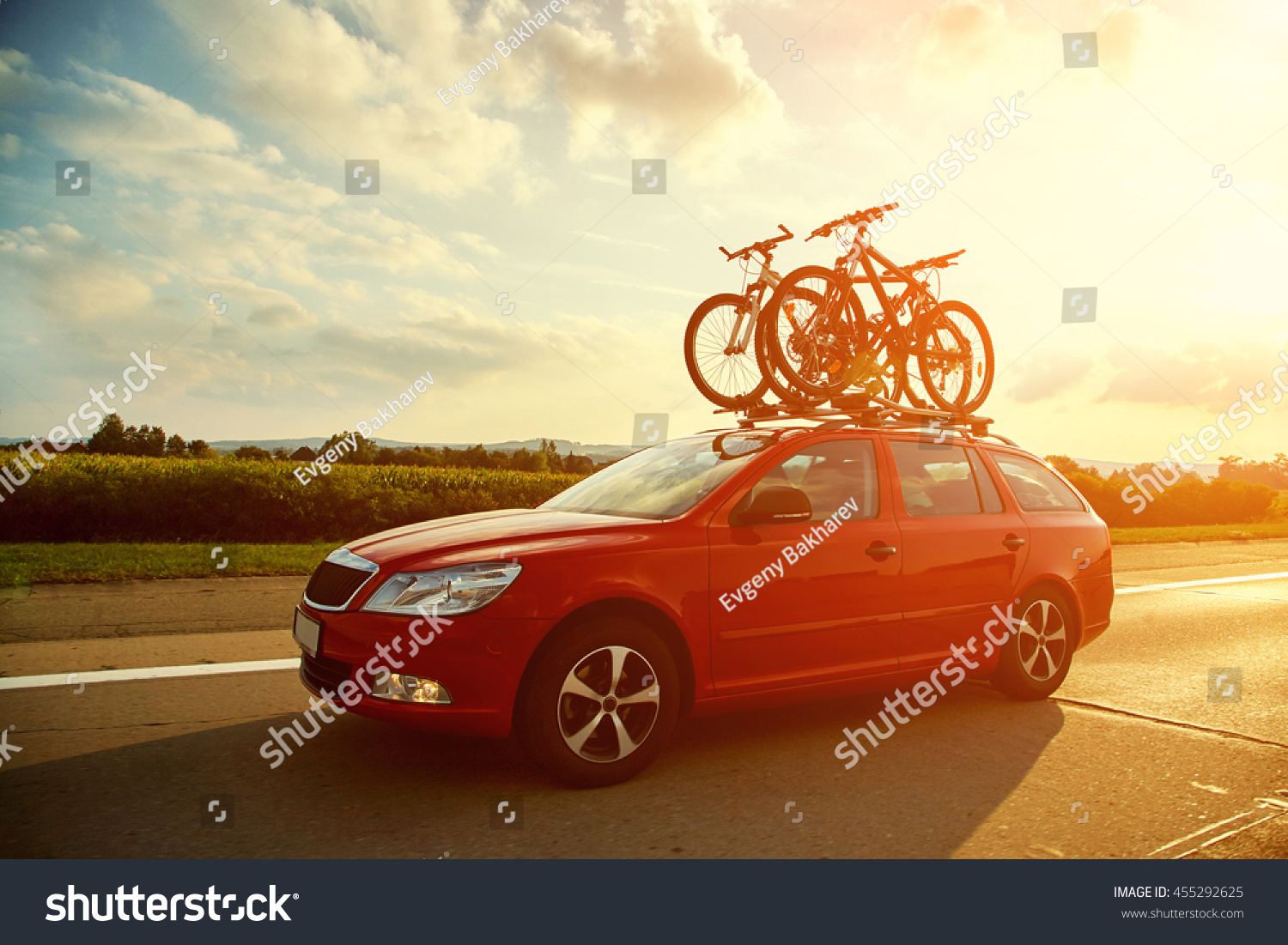 car is transporting bicycles on the roof. bikes on the trunk #455292625