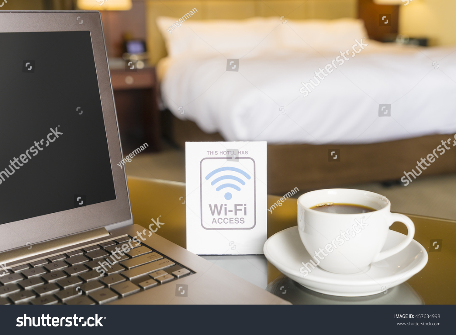 Hotel room with wifi access sign, laptop and cup of coffee #457634998