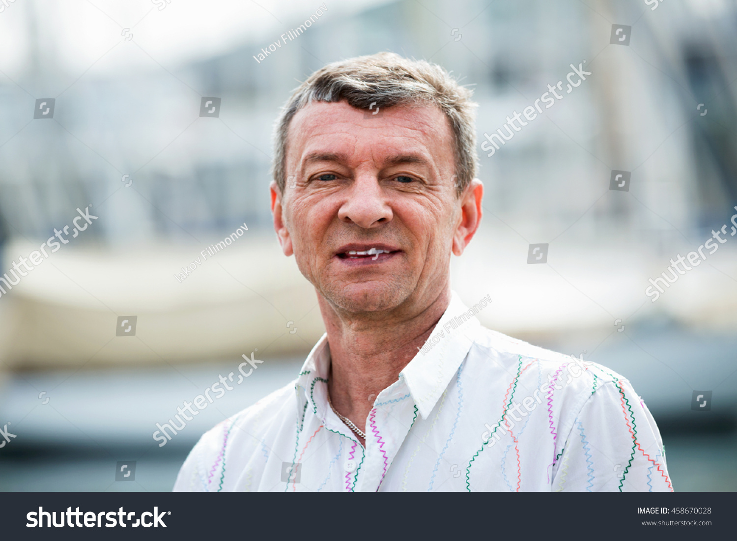 Happy smiling mature man outdoors at sunny spring day #458670028