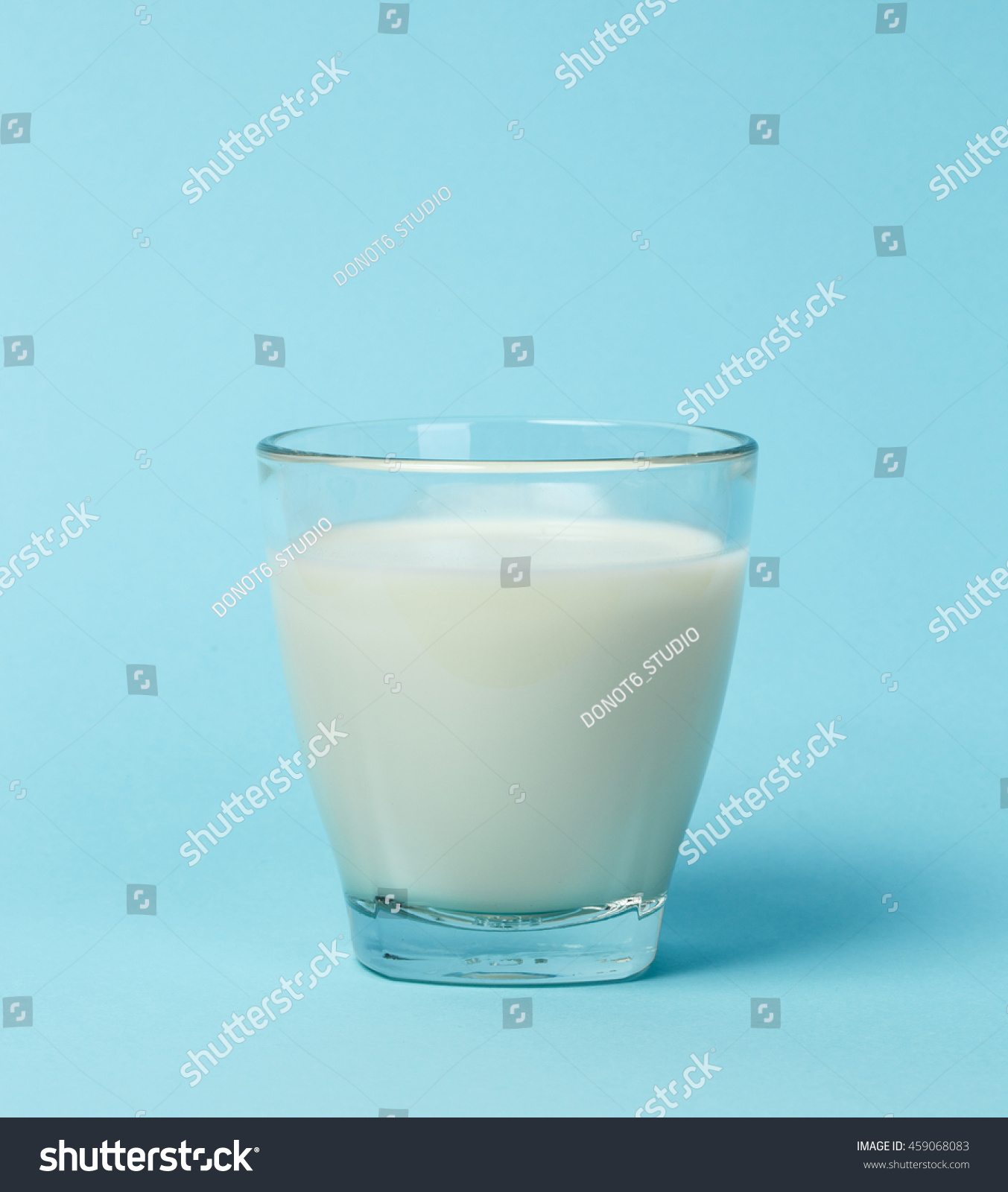 Milk glass over blue background #459068083