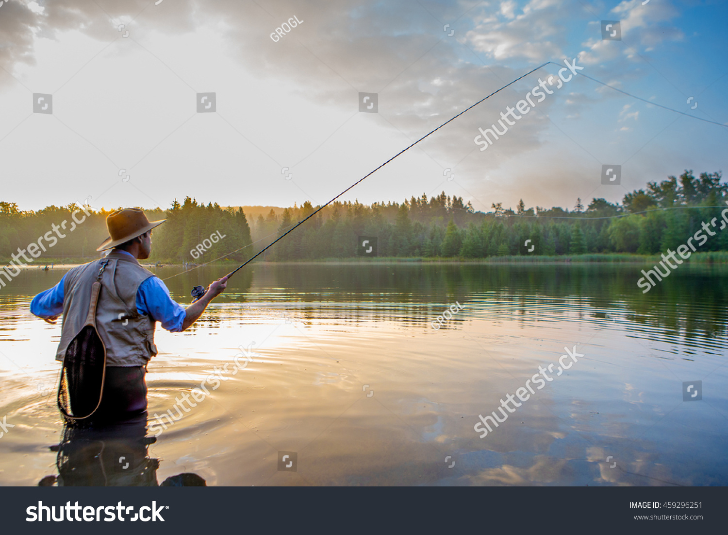 Young man flyfishing at sunrise #459296251