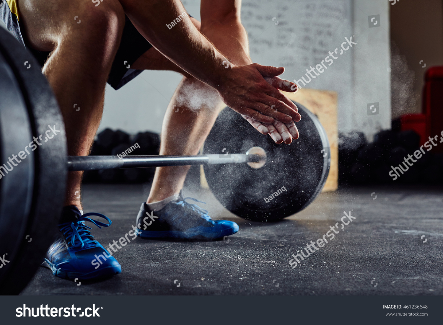 Closeup of weightlifter clapping hands before  barbell workout at the gym #461236648