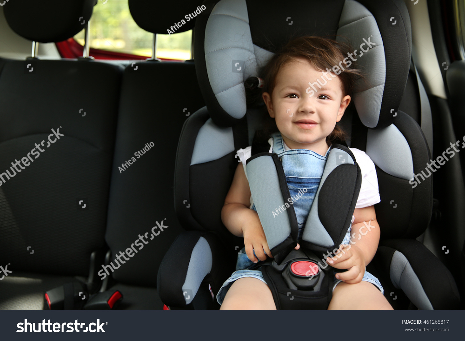 Boy sitting in a car in safety chair #461265817