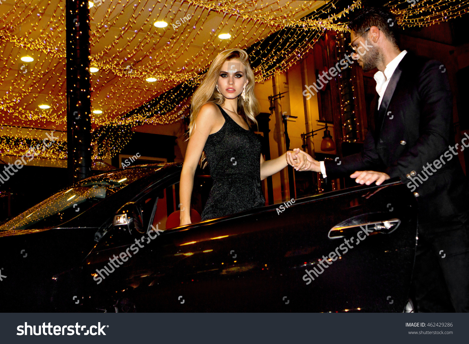 Meeting stars on the red carpet. Couple in luxury car. Night life. #462429286